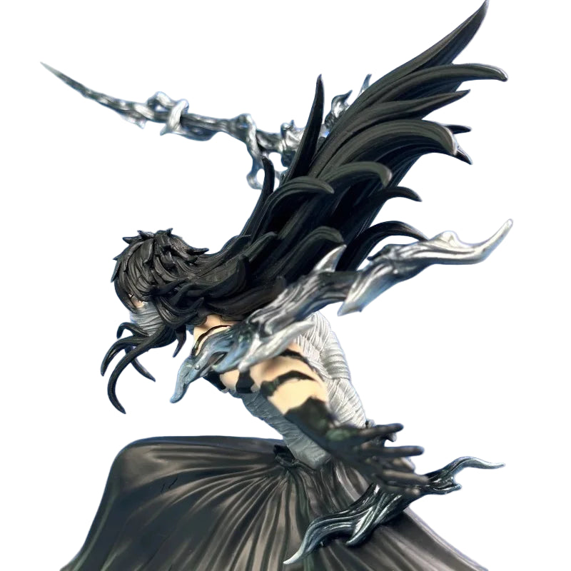 Detailed figurine of a winged creature with a gray background