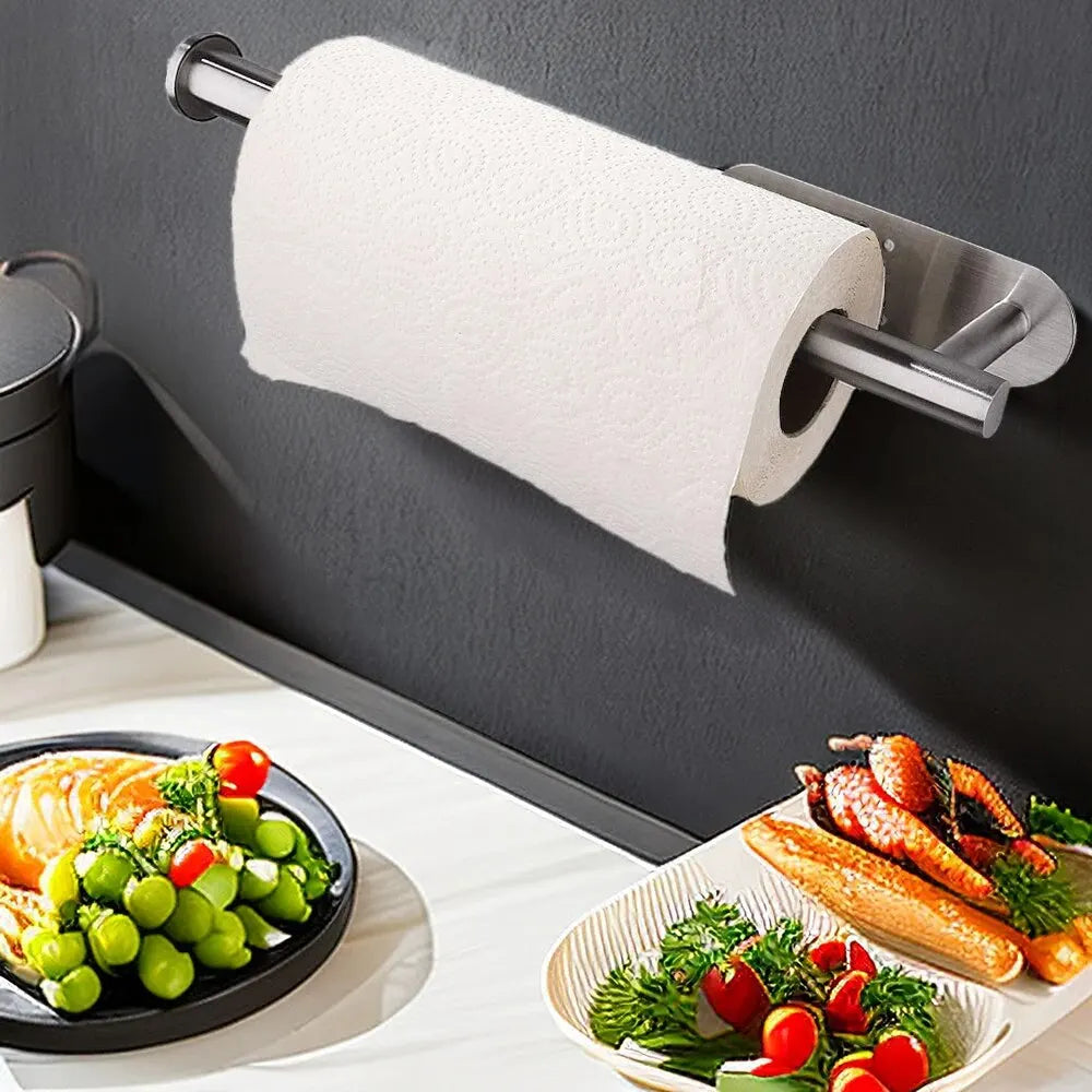 Roll of paper towels on a magnetic strip above a kitchen counter with food.