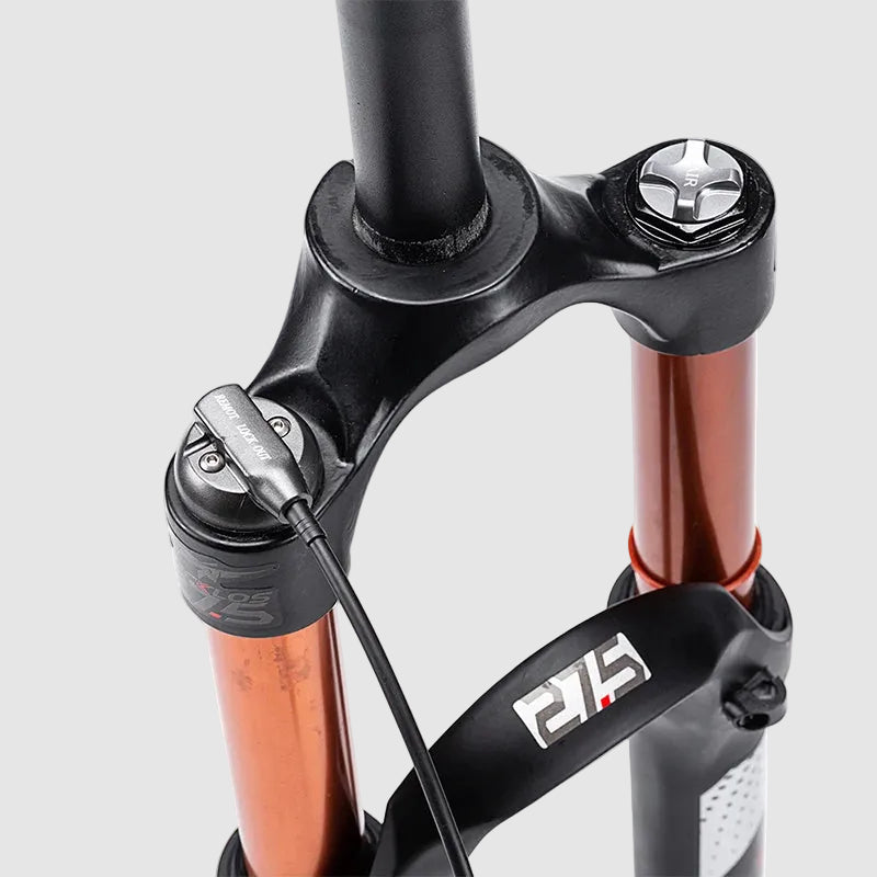 Close-up of a bicycle fork with brand logo on a white background