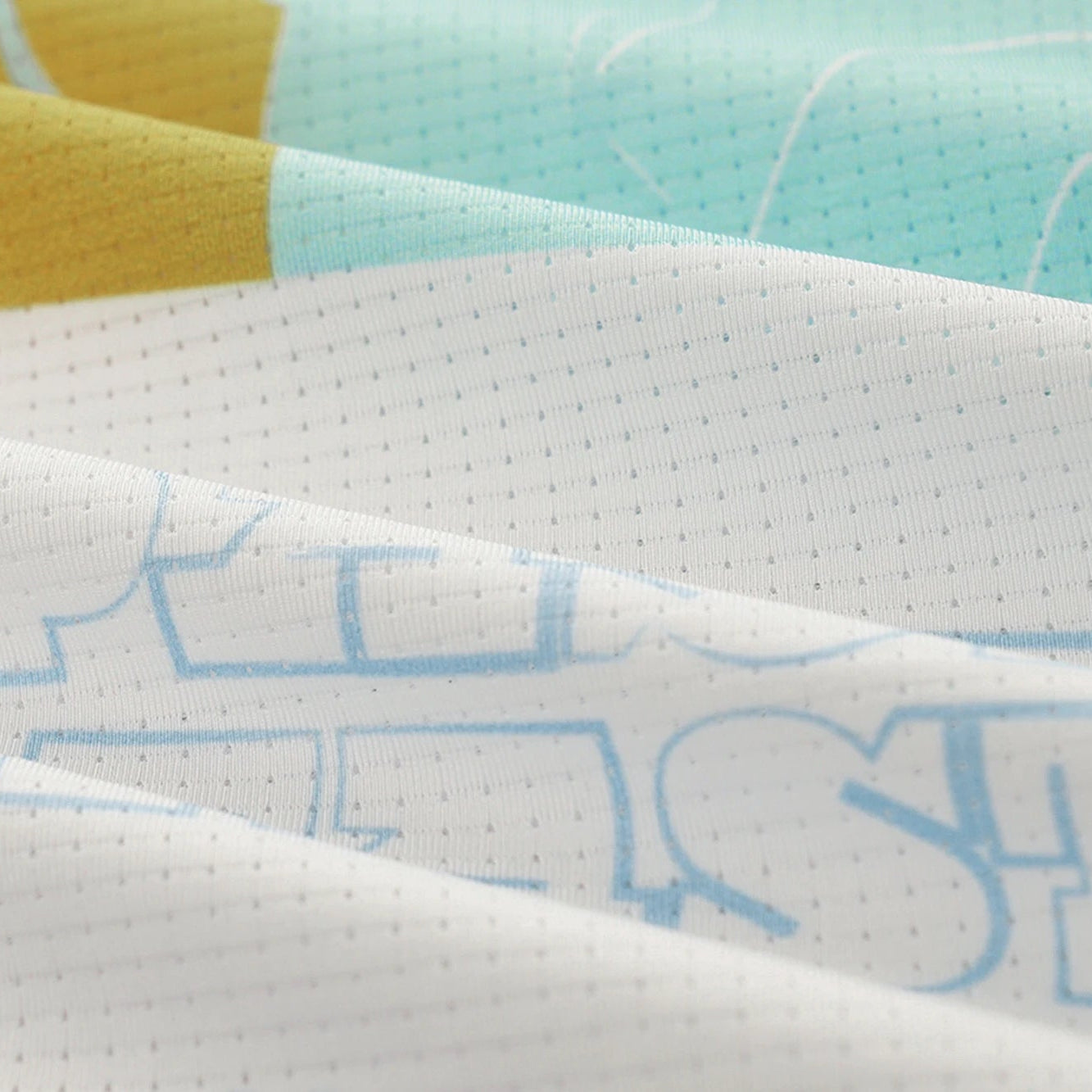 Close-up of a fabric with text and colorful patterns