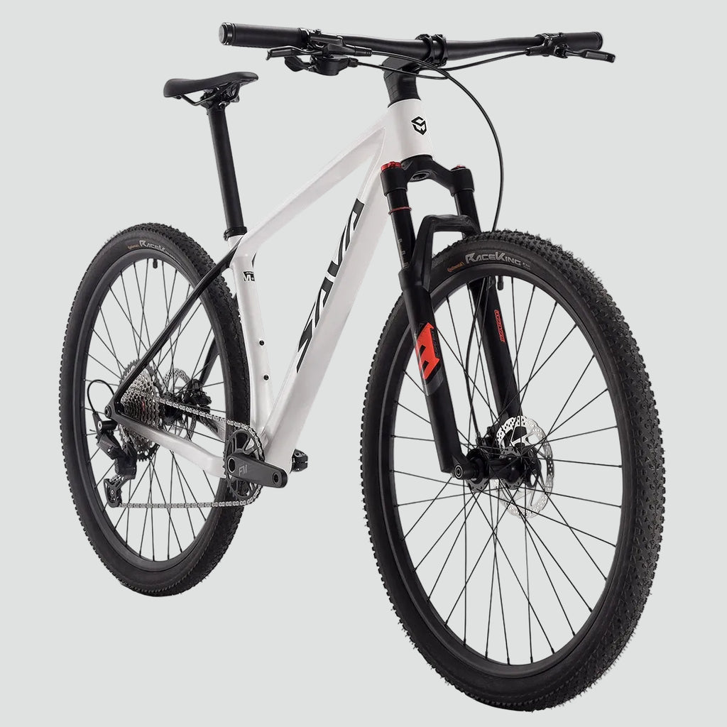 White mountain bike with black components on a light gray background