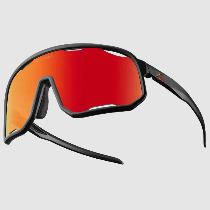 Sunglasses with red lenses and black frame on a light gray background