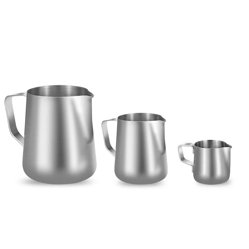 Set of three stainless steel milk pitchers on a white background