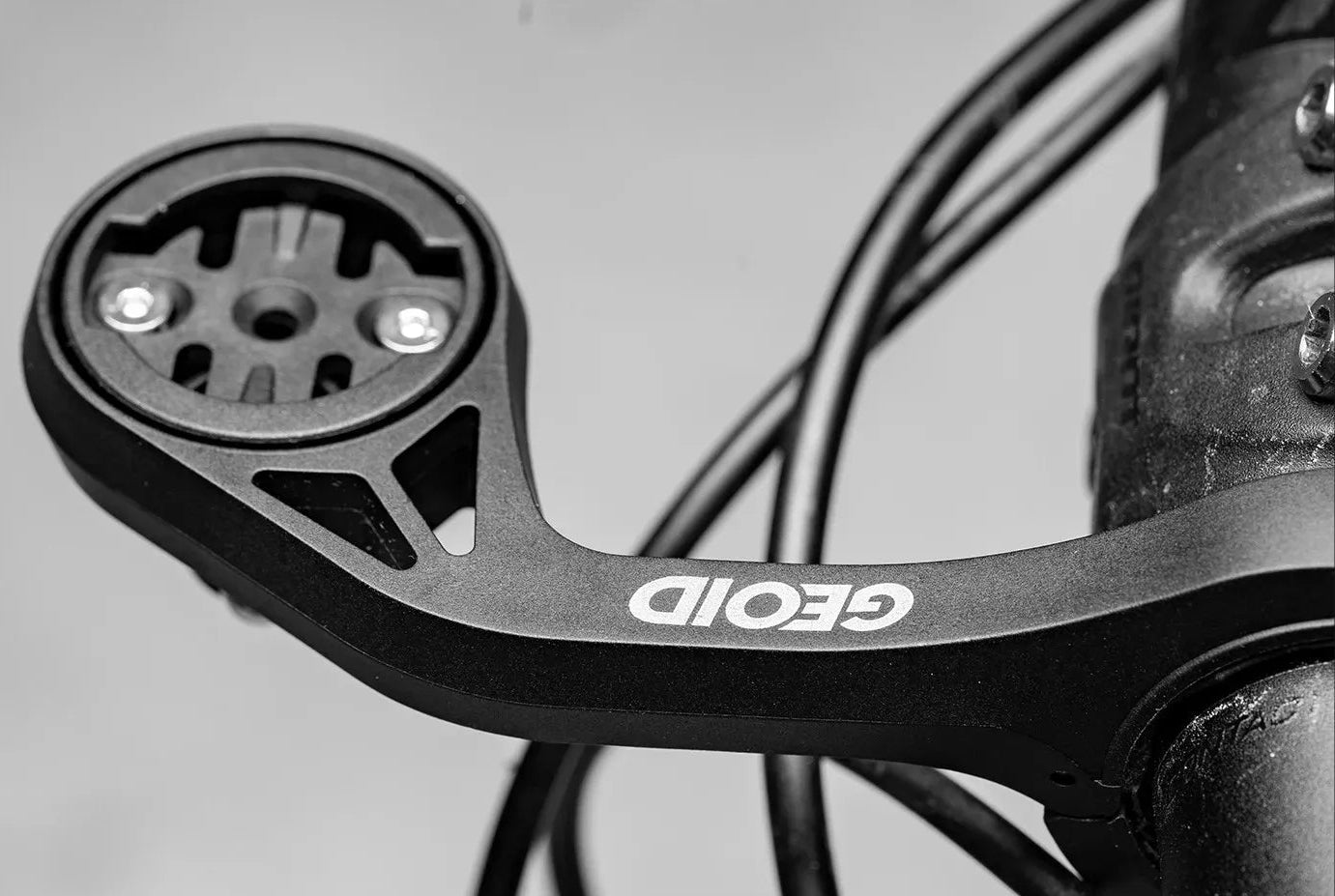 Close-up of a bicycle handlebar with 'GEOD' branding on a black background.