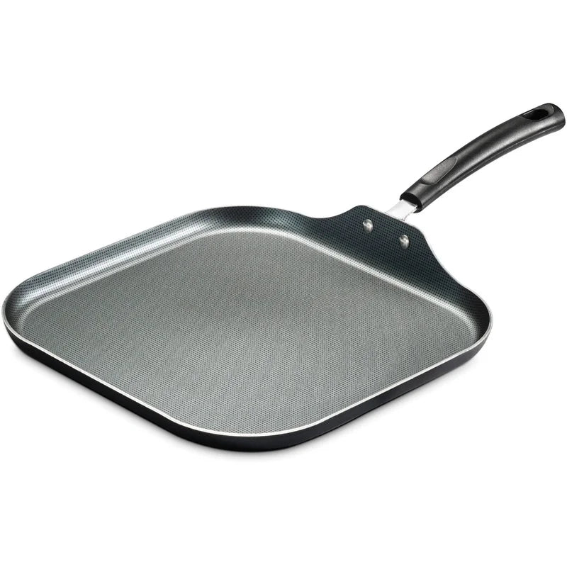 Black square grill pan with handle on a white background